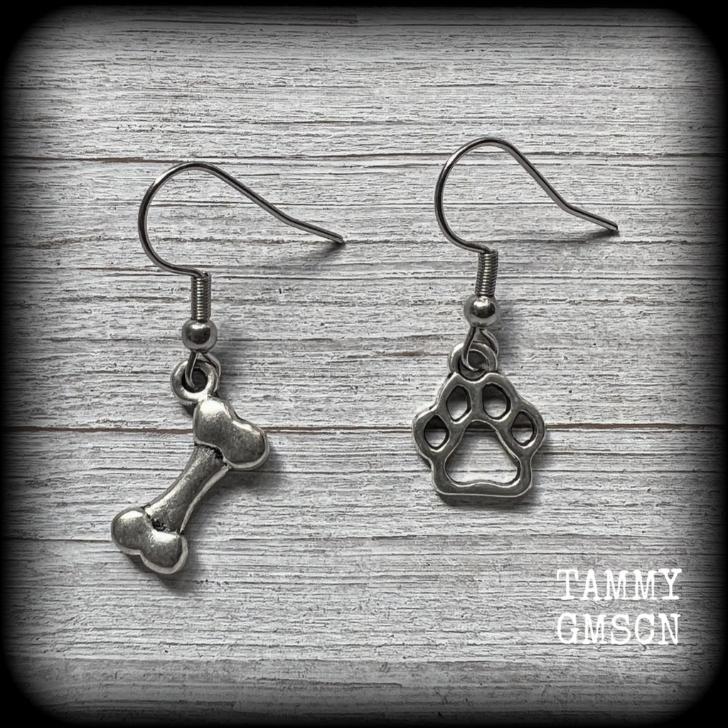 These adorable earrings feature cute classic antique silver dog bone and paw print charms, measuring just under 3cms from tip to tip, and weighing only a gram or two each.

This pair has been made with stainless steel french hooks, suitable for pierced ears.