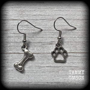 These adorable earrings feature cute classic antique silver dog bone and paw print charms, measuring just under 3cms from tip to tip, and weighing only a gram or two each.

This pair has been made with stainless steel french hooks, suitable for pierced ears.