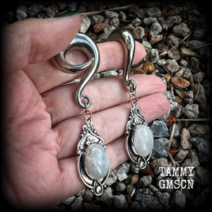 This pair of Rainbow moonstone gauged earrings feature gorgeous polished gemstones in a beautiful boho antique silver setting, lovely and dangly measuring approx 8cms from tip to tip, and weighing approx 27 grams each.  These earrings have been made on 00 gauge (10mm) surgical steel full curls, to be worn in stretched lobes.