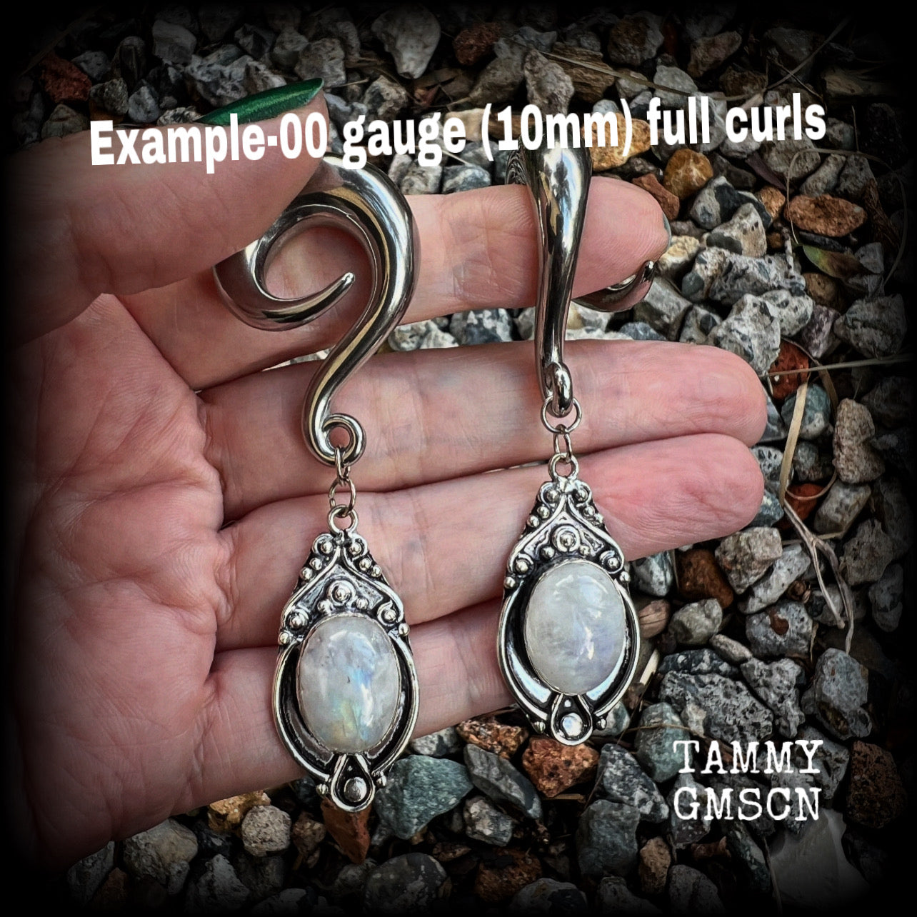 This pair of Rainbow moonstone gauged earrings feature gorgeous polished gemstones in a beautiful boho antique silver setting, lovely and dangly measuring approx 8cms from tip to tip, and weighing approx 27 grams each.  These earrings have been made on 00 gauge (10mm) surgical steel full curls, to be worn in stretched lobes.