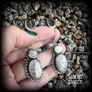 This pair of Rainbow moonstone gauged earrings feature gorgeous polished gemstones in a beautiful boho antique silver setting, lovely and dangly measuring 6.5cms from tip to tip, and weighing approx 10 grams each.  These earrings have been made on 00 gauge (10mm) surgical steel cradles, to be worn in stretched lobes.