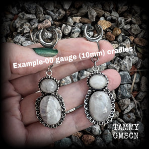 This pair of Rainbow moonstone gauged earrings feature gorgeous polished gemstones in a beautiful boho antique silver setting, lovely and dangly measuring 6.5cms from tip to tip, and weighing approx 10 grams each.  These earrings have been made on 00 gauge (10mm) surgical steel cradles, to be worn in stretched lobes.