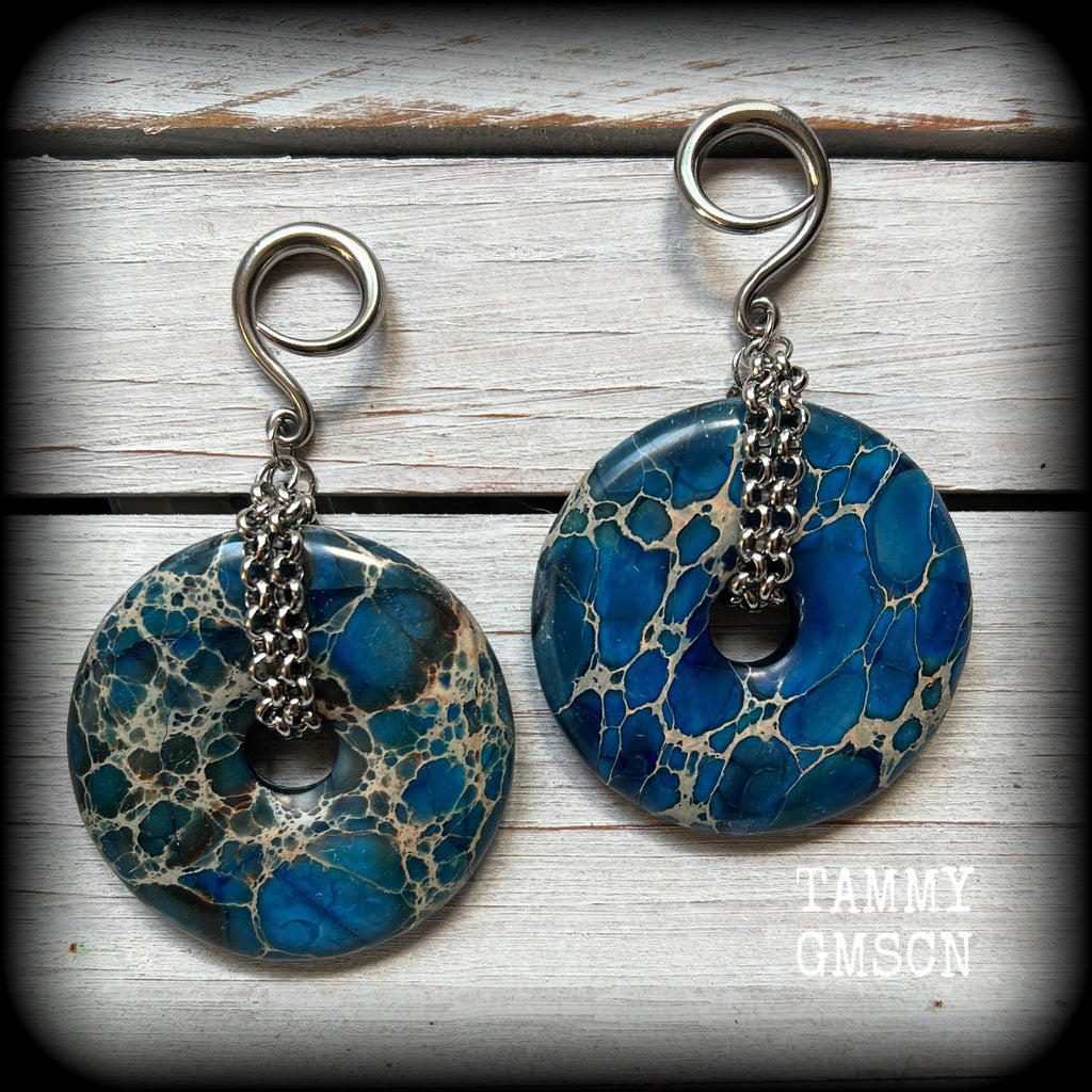This pair of gorgeous gauged earrings features a pair if deep blue ocean jasper donut gemstones cradled in stainless steel chain, measuring just over 9cms from tip to tip, and weighing approx 40 grams each.

This pair have been made on 6 gauge (4mm) surgical steel full curls, to be worn in stretched lobes.