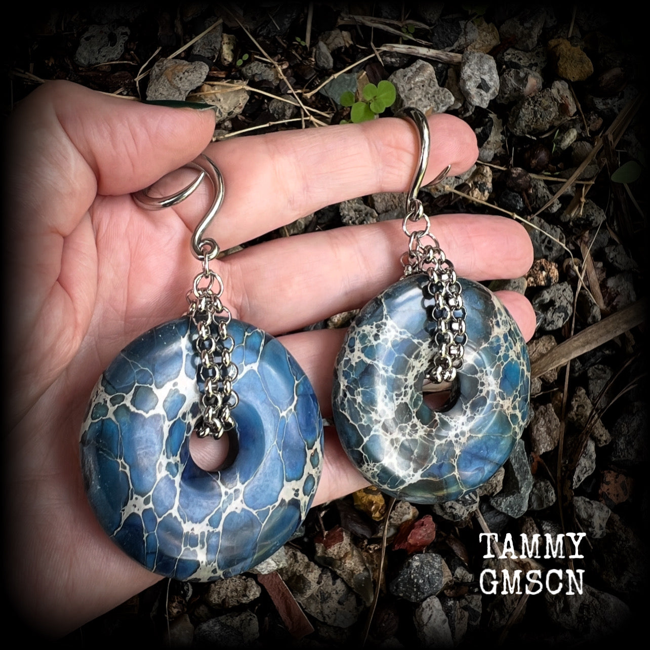 This pair of gorgeous gauged earrings features a pair if deep blue ocean jasper donut gemstones cradled in stainless steel chain, measuring just over 9cms from tip to tip, and weighing approx 40 grams each.

This pair have been made on 6 gauge (4mm) surgical steel full curls, to be worn in stretched lobes.