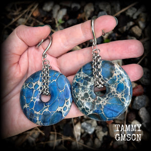 This pair of gorgeous gauged earrings features a pair if deep blue ocean jasper donut gemstones cradled in stainless steel chain, measuring just over 9cms from tip to tip, and weighing approx 40 grams each.

This pair have been made on 6 gauge (4mm) surgical steel full curls, to be worn in stretched lobes.