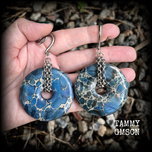 This pair of gorgeous gauged earrings features a pair if deep blue ocean jasper donut gemstones cradled in stainless steel chain, measuring just over 9cms from tip to tip, and weighing approx 40 grams each.

This pair have been made on 6 gauge (4mm) surgical steel full curls, to be worn in stretched lobes.