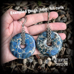 This pair of gorgeous gauged earrings features a pair if deep blue ocean jasper donut gemstones cradled in stainless steel chain, measuring just over 9cms from tip to tip, and weighing approx 40 grams each.

This pair have been made on 6 gauge (4mm) surgical steel full curls, to be worn in stretched lobes.