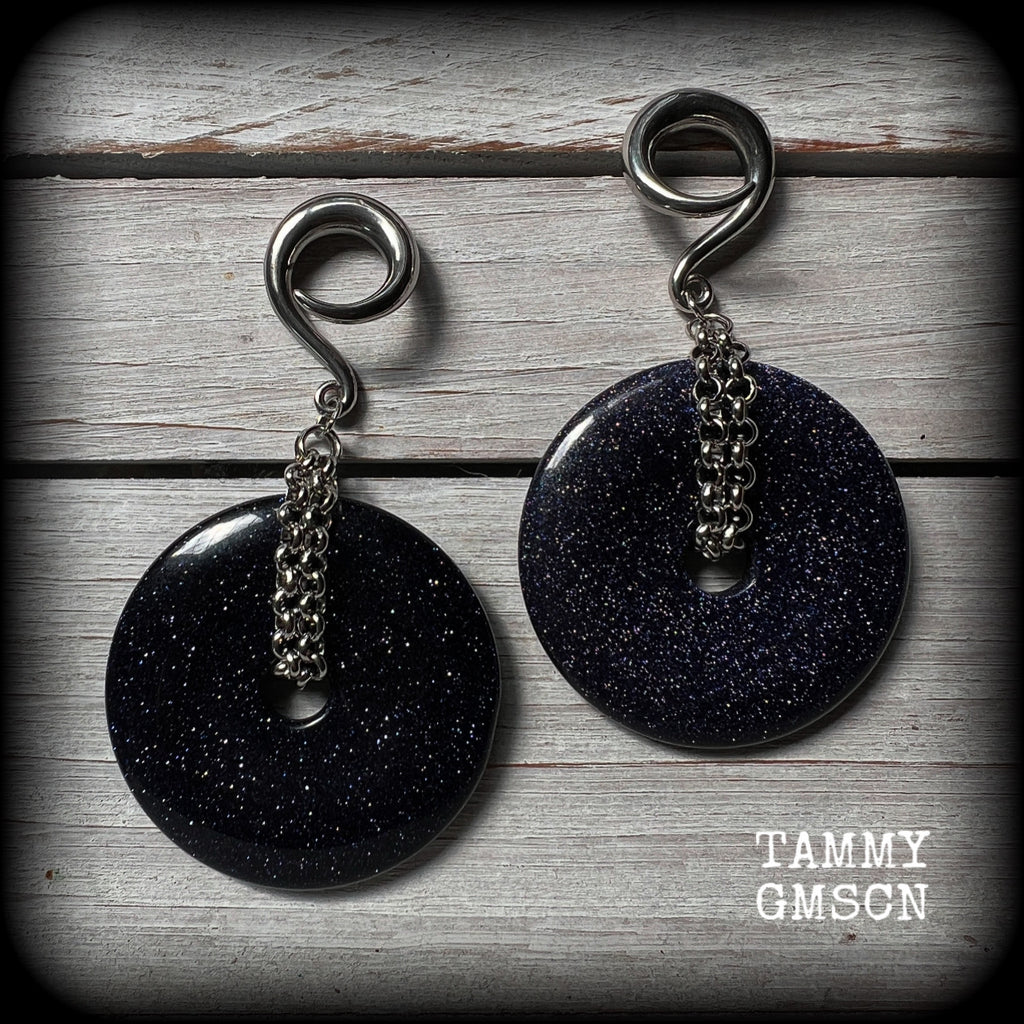 This pair of gorgeous gauged earrings features a pair of sparkly midnight blue sandstone donut gemstones cradled in stainless steel chain, measuring just over 9cms from tip to tip, and weighing approx 34 grams each.

This pair have been made on 2 gauge (6mm) surgical steel full curls, to be worn in stretched lobes.