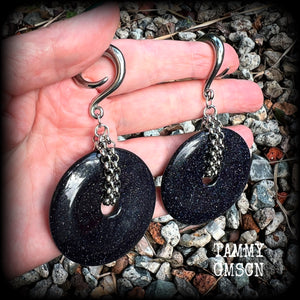 This pair of gorgeous gauged earrings features a pair of sparkly midnight blue sandstone donut gemstones cradled in stainless steel chain, measuring just over 9cms from tip to tip, and weighing approx 34 grams each.

This pair have been made on 2 gauge (6mm) surgical steel full curls, to be worn in stretched lobes.