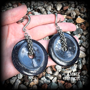 This pair of gorgeous gauged earrings features a pair of sparkly midnight blue sandstone donut gemstones cradled in stainless steel chain, measuring just over 9cms from tip to tip, and weighing approx 34 grams each.

This pair have been made on 2 gauge (6mm) surgical steel full curls, to be worn in stretched lobes.