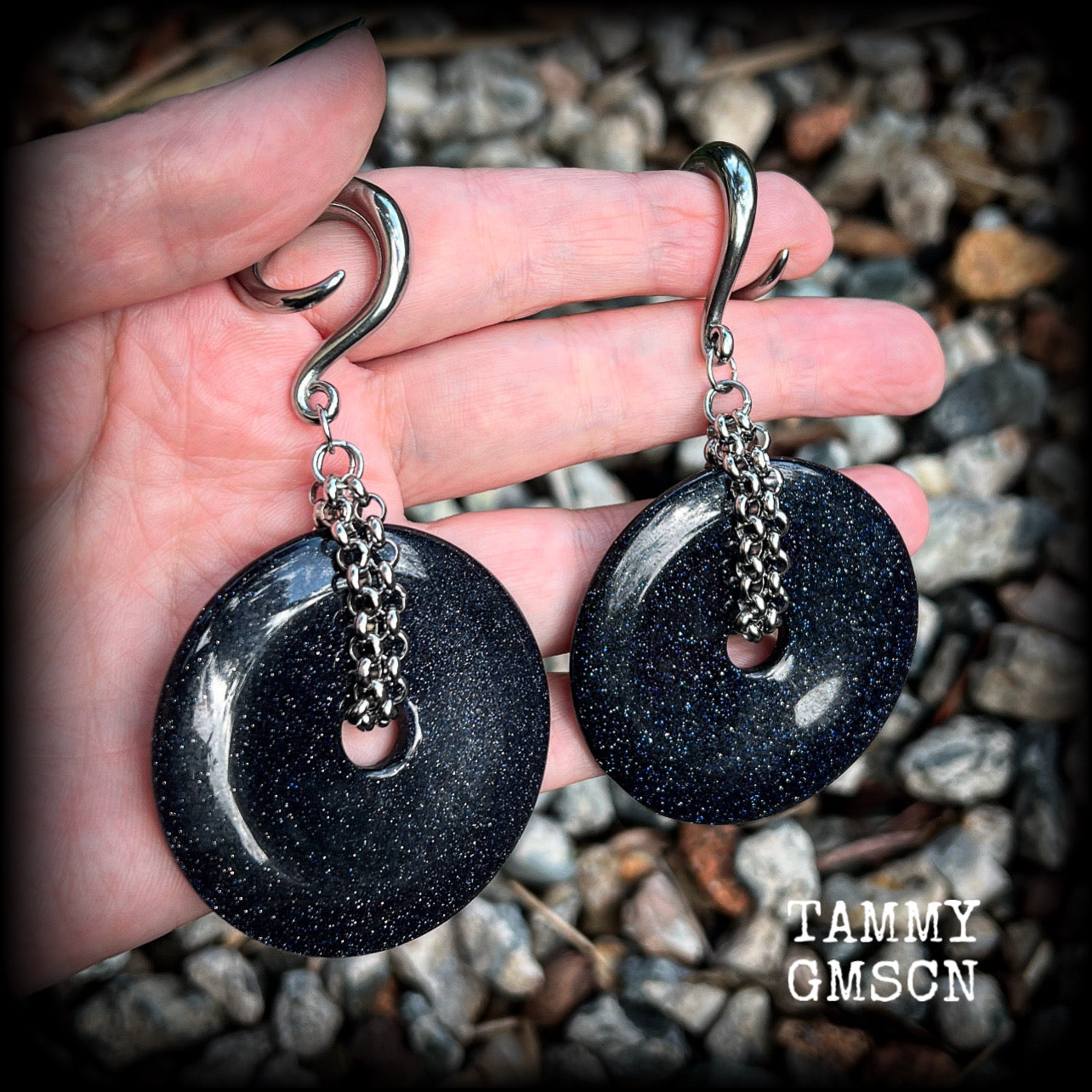 This pair of gorgeous gauged earrings features a pair of sparkly midnight blue sandstone donut gemstones cradled in stainless steel chain, measuring just over 9cms from tip to tip, and weighing approx 34 grams each.

This pair have been made on 2 gauge (6mm) surgical steel full curls, to be worn in stretched lobes.
