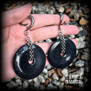 This pair of gorgeous gauged earrings features a pair of sparkly midnight blue sandstone donut gemstones cradled in stainless steel chain, measuring just over 9cms from tip to tip, and weighing approx 34 grams each.

This pair have been made on 2 gauge (6mm) surgical steel full curls, to be worn in stretched lobes.