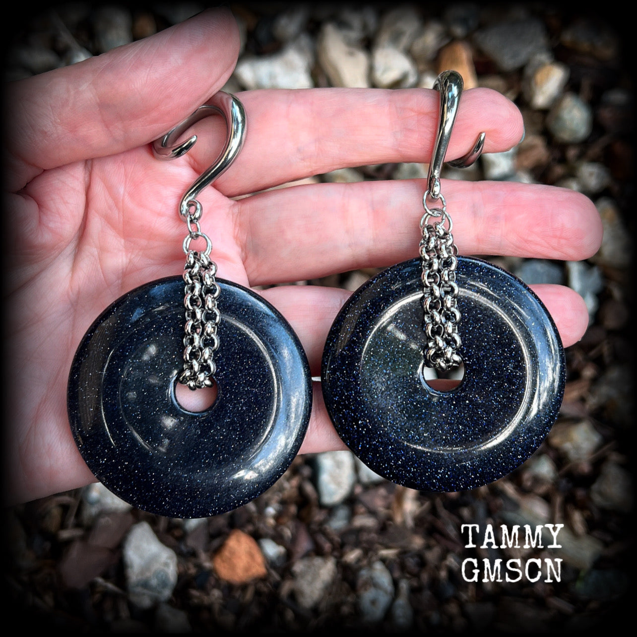 This pair of gorgeous gauged earrings features a pair of sparkly midnight blue sandstone donut gemstones cradled in stainless steel chain, measuring just over 9cms from tip to tip, and weighing approx 34 grams each.

This pair have been made on 2 gauge (6mm) surgical steel full curls, to be worn in stretched lobes.