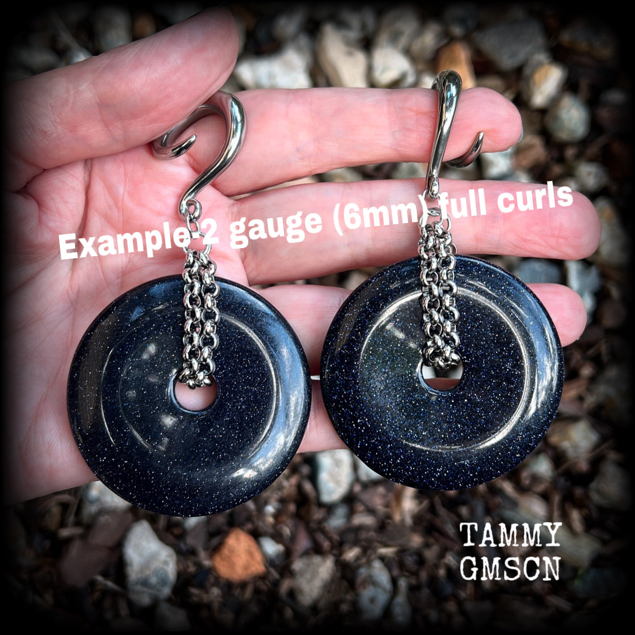 This pair of gorgeous gauged earrings features a pair of sparkly midnight blue sandstone donut gemstones cradled in stainless steel chain, measuring just over 9cms from tip to tip, and weighing approx 34 grams each.

This pair have been made on 2 gauge (6mm) surgical steel full curls, to be worn in stretched lobes.