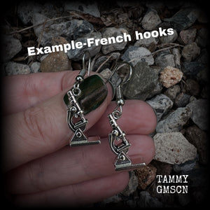 These earrings feature a pair of antique silver microscopes, measuring just on 4.5cms from tip to tip, and weighing only a few grams each.

This pair have been made with surgical steel french hooks, to be worn in pierced ears.