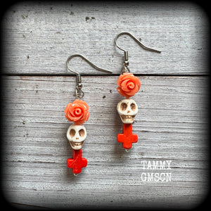 This pair of beautiful earrings features gorgeous pumpkin spice coloured roses and crosses with bone white howlite stone skulls.
Measuring just under 6cms from tip to tip and weighing only a gram or two each, these are lovely and lightweight, and nice and dangly.

This pair have been made with stainless steel french hooks, for pierced ears.