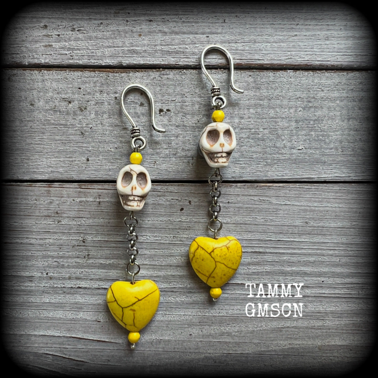 This pair of beautiful earrings features gorgeous canary yellow stone hearts dangling beneath bone white howlite stone skulls, measuring just on 9cms from tip to tip and weighing approx. 6 grams each, these are nice and dangly and not too heavy.

This pair have been made with small antique silver shephard hooks, suitable for stretched lobes when worn with silicone earlets from 8 gauge (3mm).
