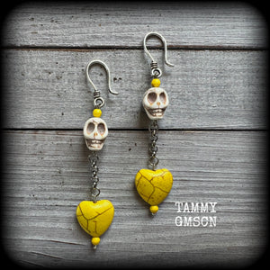 This pair of beautiful earrings features gorgeous canary yellow stone hearts dangling beneath bone white howlite stone skulls, measuring just on 9cms from tip to tip and weighing approx. 6 grams each, these are nice and dangly and not too heavy.

This pair have been made with small antique silver shephard hooks, suitable for stretched lobes when worn with silicone earlets from 8 gauge (3mm).