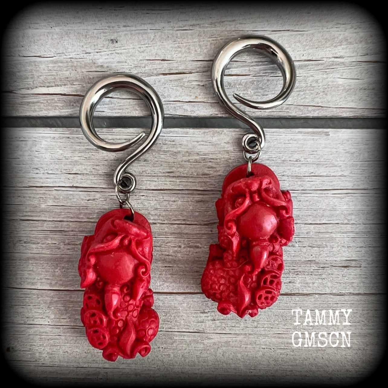 These gorgeous earrings feature stunning deep red Cinnabar Pi Xui lions, measuring just over 6cms from tip to tip, and weighing approx 9 grams each.

This pair has been made with 6 gauge (4mm) surgical steel full curl hooks, suitable for stretched lobes.
