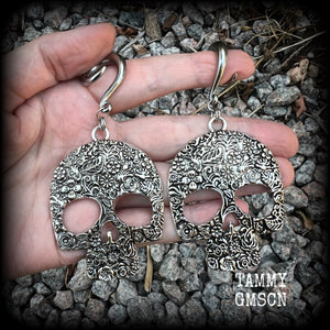 Featuring large antique silver skulls with floral detail, these earrings are perfect for Day of the Dead celebrations!

These gorgeous earrings weigh in at approx. 20 grams a piece, and nice and dangly at just under 10cms from tip to tip.

This pair of beautiful gauged earrings has been made with 2 gauge (6mm) surgical steel full curl hooks, suitable for stretched lobes.