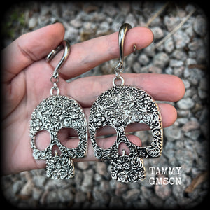 Featuring large antique silver skulls with floral detail, these earrings are perfect for Day of the Dead celebrations!

These gorgeous earrings weigh in at approx. 20 grams a piece, and nice and dangly at just under 10cms from tip to tip.

This pair of beautiful gauged earrings has been made with 2 gauge (6mm) surgical steel full curl hooks, suitable for stretched lobes.