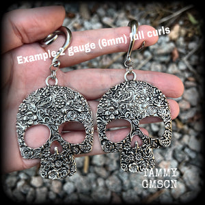Featuring large antique silver skulls with floral detail, these earrings are perfect for Day of the Dead celebrations!

These gorgeous earrings weigh in at approx. 20 grams a piece, and nice and dangly at just under 10cms from tip to tip.

This pair of beautiful gauged earrings has been made with 2 gauge (6mm) surgical steel full curl hooks, suitable for stretched lobes.
