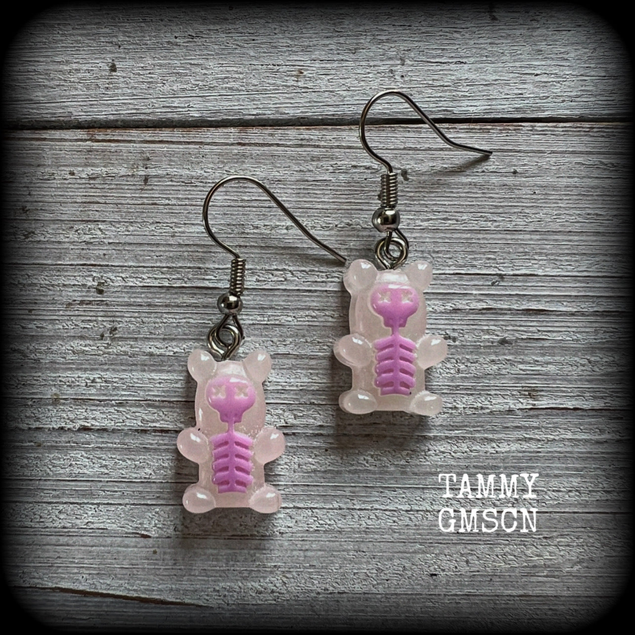 Featuring spooky cute pink skeleton gummy bears, these adorable earrings measure just on 5cms from tip to tip and are super light weight, weighing only a gram or two each.

This pair has been made with stainless steel french hooks, to be worn in pierced ears.