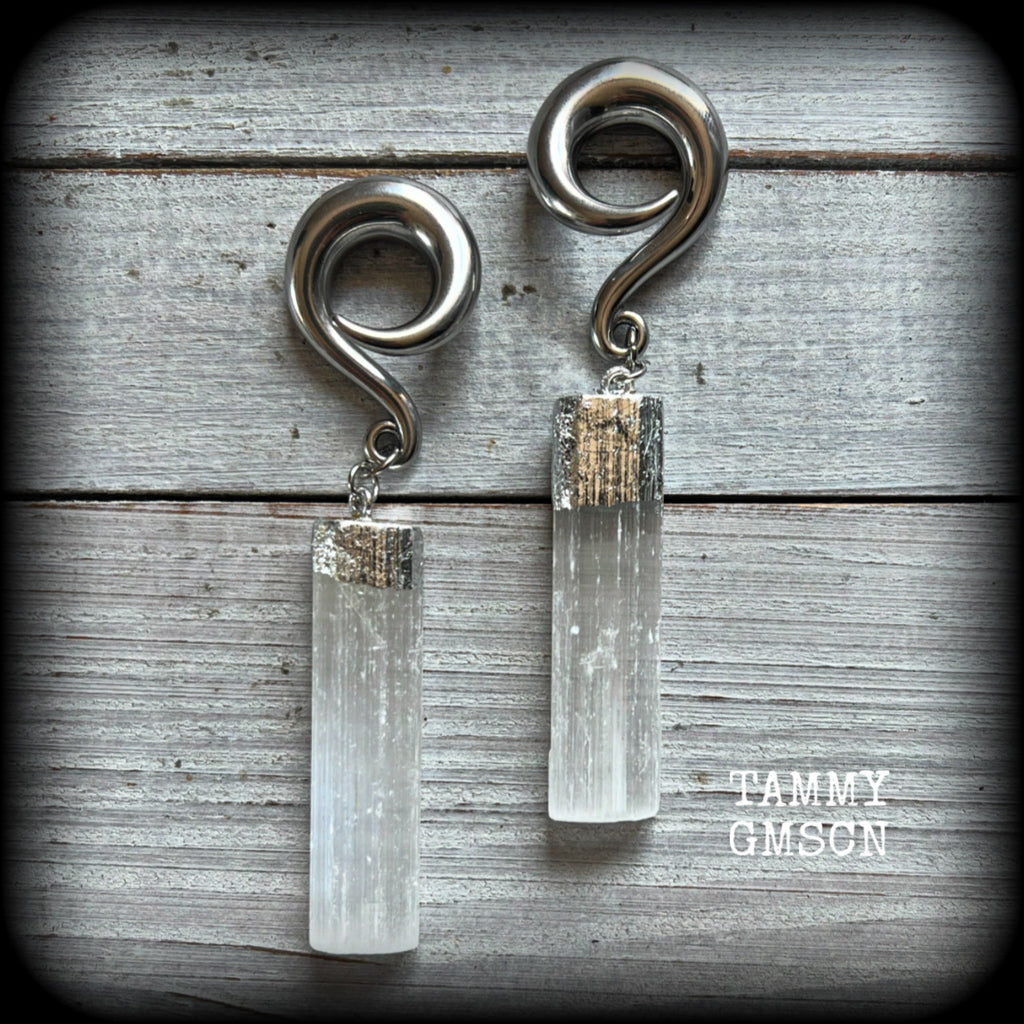 These beautiful gauged earrings feature gorgeous selenite pieces, measuring just over 9cms from tip to tip, and weighing approx 22 grams each.

This pair have been made on 0 gauge (8mm) surgical steel full curl hooks, to be worn in stretched lobes.
