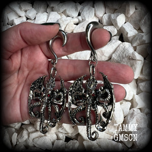 These ungodly gauged earrings feature big beautiful antique silver winged Cthulhu charms with glowing red eyes, weighing in at 33 grams a piece, and measure just on 9.5cms from tip to tip.  This pair has been made on 0 gauge (8mm) surgical steel half curl hooks, suitable for stretched lobes.
