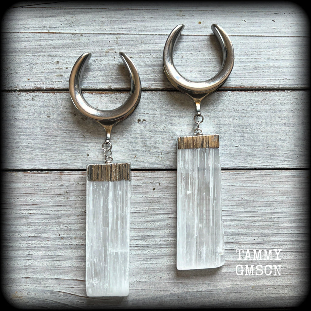 Featuring the biggest selenite pieces we could get our hands on, these earrings are big and beautiful, measuring just on 12cms from tip to tip, and weighing approx 33 grams each.

This pair have been made on 1.18” gauge (30mm) surgical steel cradles, to be worn in stretched lobes.