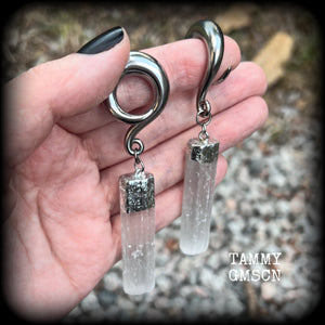 These beautiful gauged earrings feature gorgeous selenite pieces, measuring just over 9cms from tip to tip, and weighing approx 22 grams each.

This pair have been made on 0 gauge (8mm) surgical steel full curl hooks, to be worn in stretched lobes.

