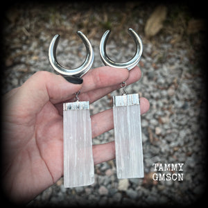 Featuring the biggest selenite pieces we could get our hands on, these earrings are big and beautiful, measuring just on 12cms from tip to tip, and weighing approx 33 grams each.

This pair have been made on 1.18” gauge (30mm) surgical steel cradles, to be worn in stretched lobes.