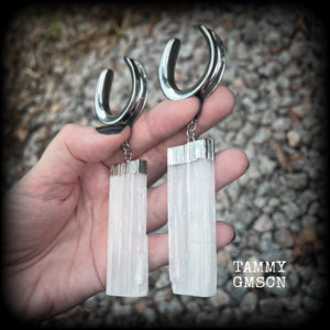 Featuring the biggest selenite pieces we could get our hands on, these earrings are big and beautiful, measuring just on 12cms from tip to tip, and weighing approx 33 grams each.

This pair have been made on 1.18” gauge (30mm) surgical steel cradles, to be worn in stretched lobes.