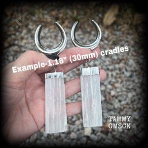 Featuring the biggest selenite pieces we could get our hands on, these earrings are big and beautiful, measuring just on 12cms from tip to tip, and weighing approx 33 grams each.

This pair have been made on 1.18” gauge (30mm) surgical steel cradles, to be worn in stretched lobes.