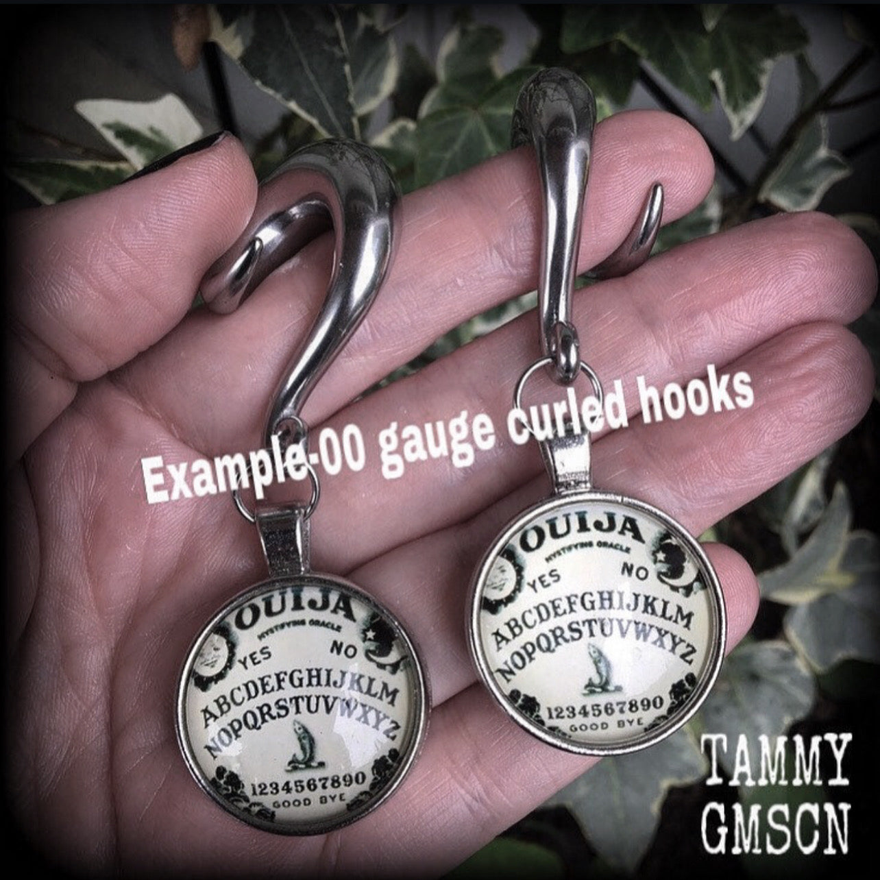 Featuring a double sided Ouija board dome pendant, these awesome earrings weigh approx 32 grams a piece, and measure just on 8cms from tip to tip.

This pair have been made with 00 gauge (10mm) surgical steel full curl hooks, suitable for stretched lobes.

