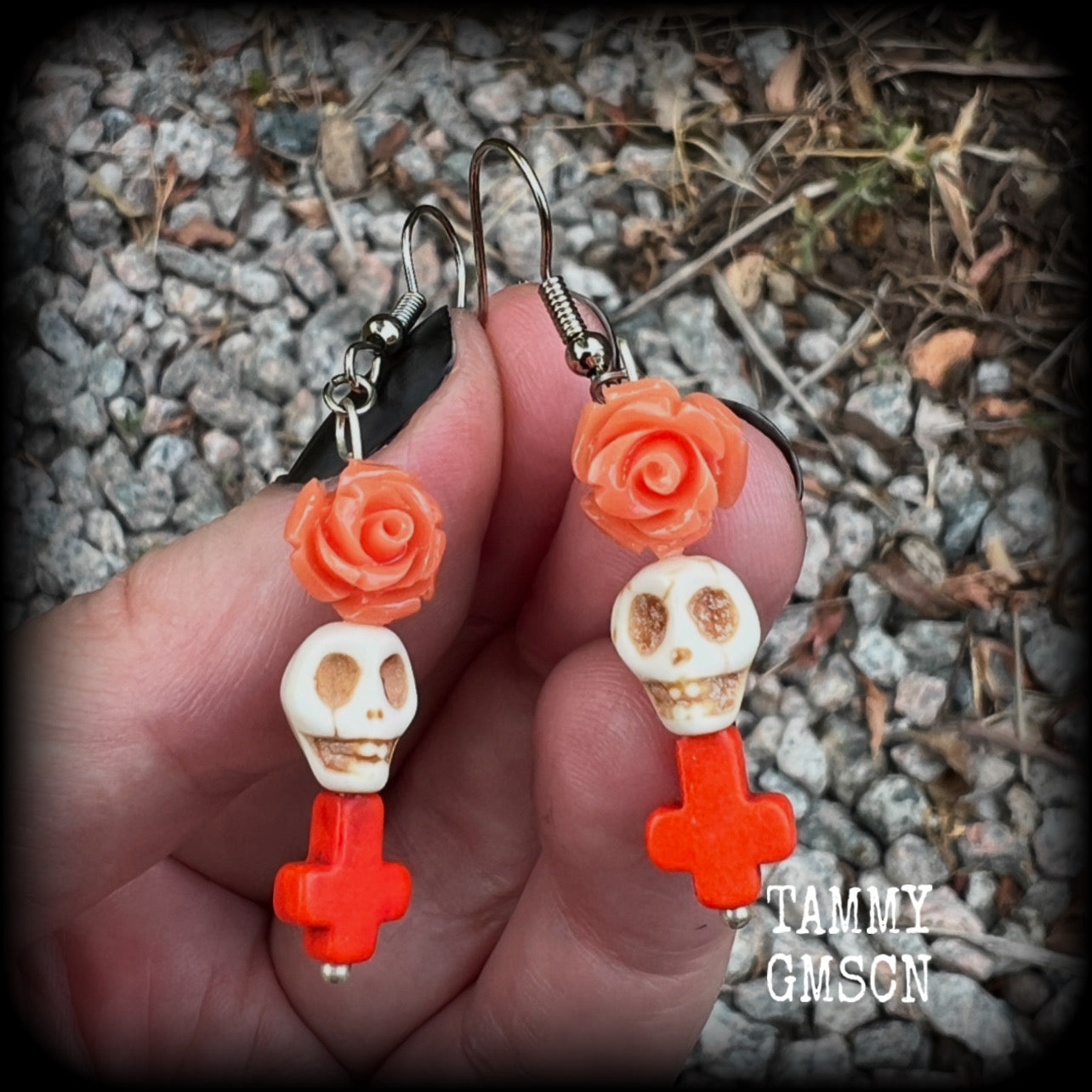 This pair of beautiful earrings features gorgeous pumpkin spice coloured roses and crosses with bone white howlite stone skulls. Measuring just under 6cms from tip to tip and weighing only a gram or two each, these are lovely and lightweight, and nice and dangly.  This pair have been made with stainless steel french hooks, for pierced ears.