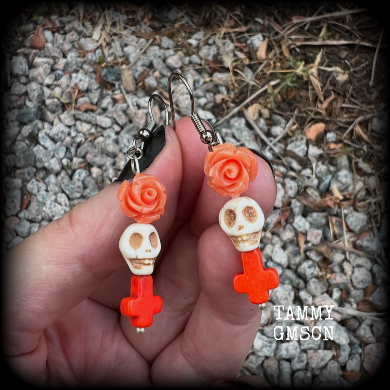 This pair of beautiful earrings features gorgeous pumpkin spice coloured roses and crosses with bone white howlite stone skulls. Measuring just under 6cms from tip to tip and weighing only a gram or two each, these are lovely and lightweight, and nice and dangly.  This pair have been made with stainless steel french hooks, for pierced ears.