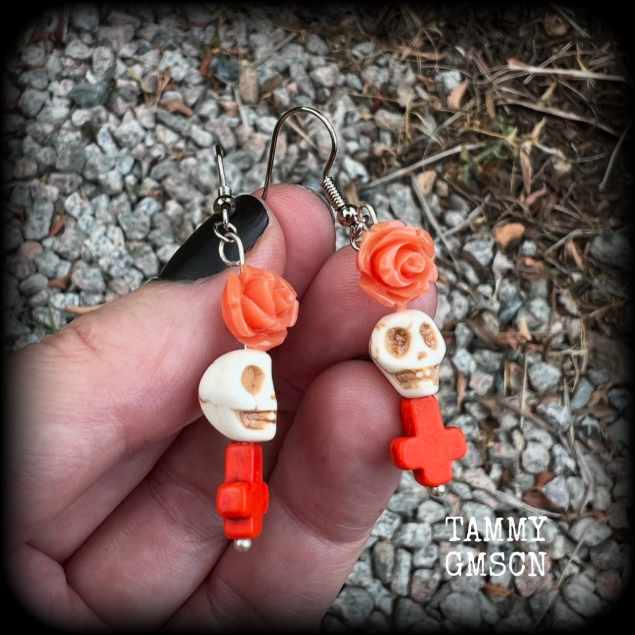 This pair of beautiful earrings features gorgeous pumpkin spice coloured roses and crosses with bone white howlite stone skulls. Measuring just under 6cms from tip to tip and weighing only a gram or two each, these are lovely and lightweight, and nice and dangly.  This pair have been made with stainless steel french hooks, for pierced ears.