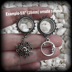 These gorgeous tunnels feature folk horror inspired antique silver crescent moon and esoteric sun charms, are super light weight at just 5 grams each and measure just over 4.5 cms from tip to tip.

This pair has been made with 5/8” gauge (16mm) ornate surgical steel screw fit tunnels-for stretched lobes.