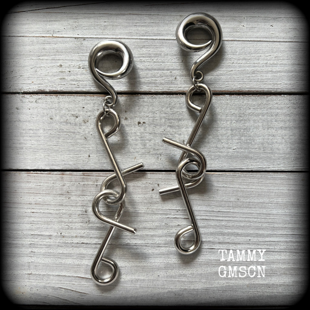 These awesome gauged earrings feature twisted and knotted surgical steel pieces, weighing approx 26 grams a piece, and super dangly at just on 13cms from tip to tip.

This pair has been made with 0 gauge (8mm) surgical steel full curl hooks, suitable for stretched lobes.
