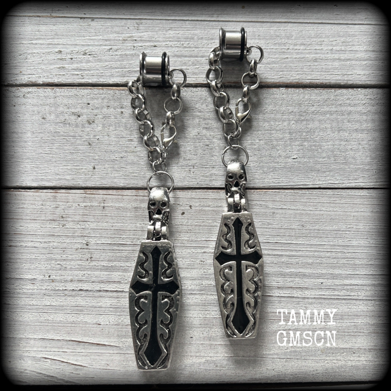 These beautiful antique silver and black enamel coffin tunnel dangles are nice and dangly, weighing approx 25 grams each, and measuring just over 11cms from tip to tip.

⚰️ This listing is for a chunky chain/lobster clasp combination suitable for 00 gauge and larger. 
If you choose a smaller size of tunnel than 00 gauge we will make these on a smaller chain.