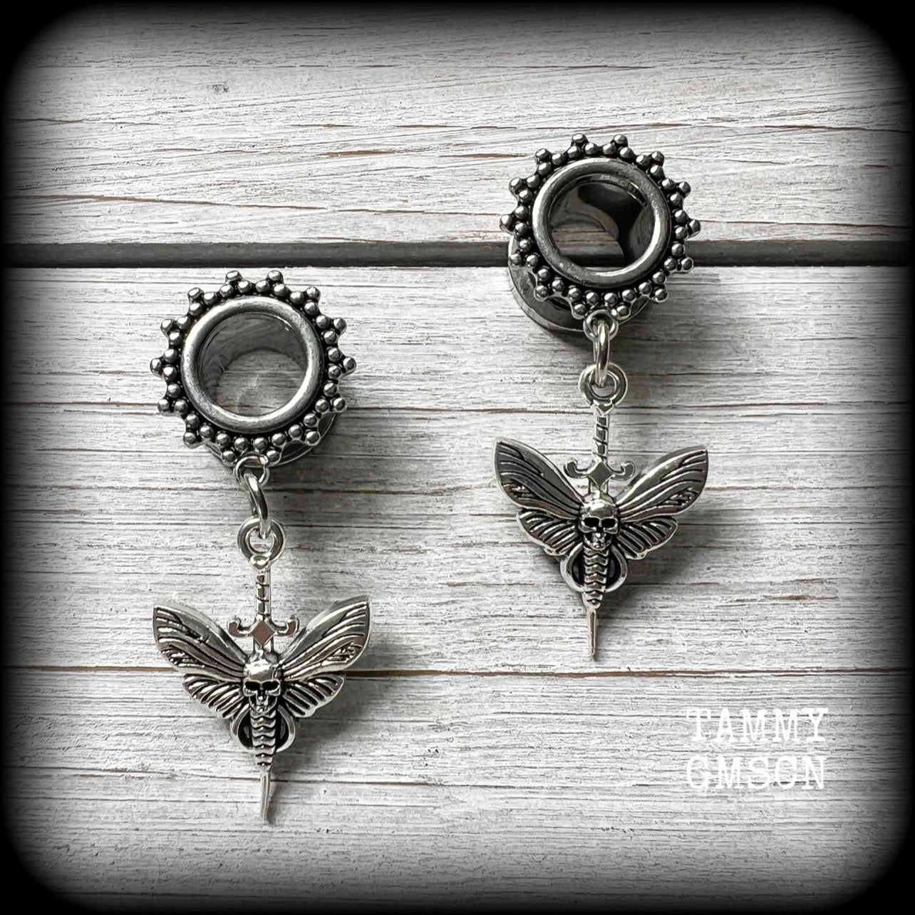 These awesome tunnel earrings feature antique silver deathshead moth and dagger charms, are nice and light weight at only 7 grams each and measure just under 5cms from tip to tip.

This pair have been made with 00 gauge (10mm) surgical steel screw fit ornate tunnels.