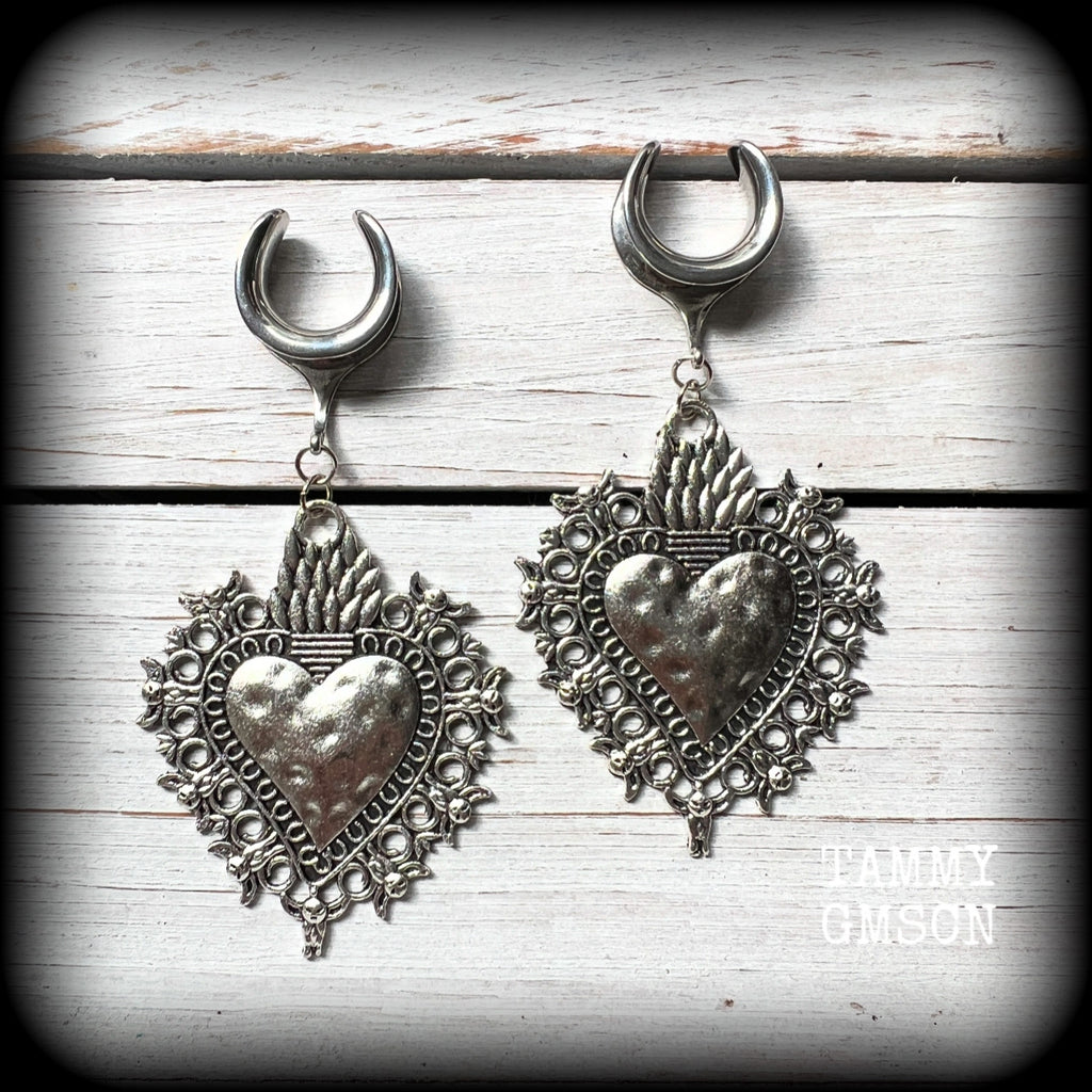 These gorgeous antique silver gauged earrings feature big beautiful sacred hearts, measuring 9cms from tip to tip, and weighing approx 14 grams each.

This pair has been made on 5/8” gauge (16mm) surgical steel cradles, to be worn in stretched lobes.