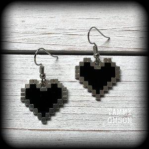 This pair of super cute earrings features black enamel and antique silver pixel hearts, measuring just under 4cms from tip to tip, and weighing only a few grams each.

This pair has been made with stainless steel french hooks, to be worn in pierced ears.