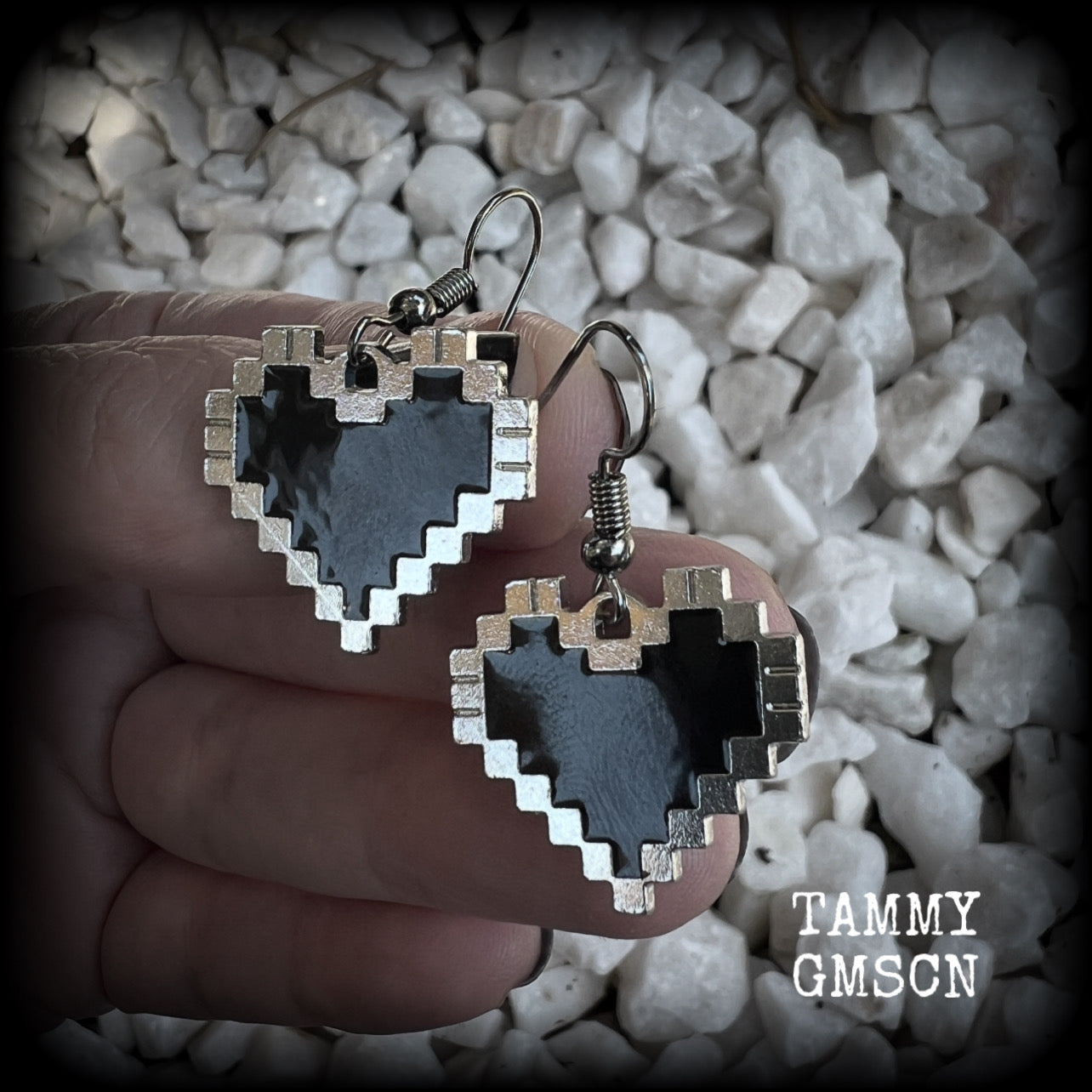 This pair of super cute earrings features black enamel and antique silver pixel hearts, measuring just under 4cms from tip to tip, and weighing only a few grams each.  This pair has been made with stainless steel french hooks, to be worn in pierced ears.