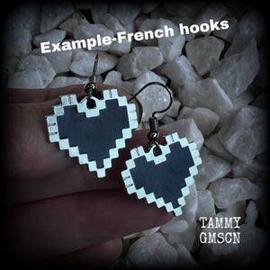 This pair of super cute earrings features black enamel and antique silver pixel hearts, measuring just under 4cms from tip to tip, and weighing only a few grams each.  This pair has been made with stainless steel french hooks, to be worn in pierced ears.