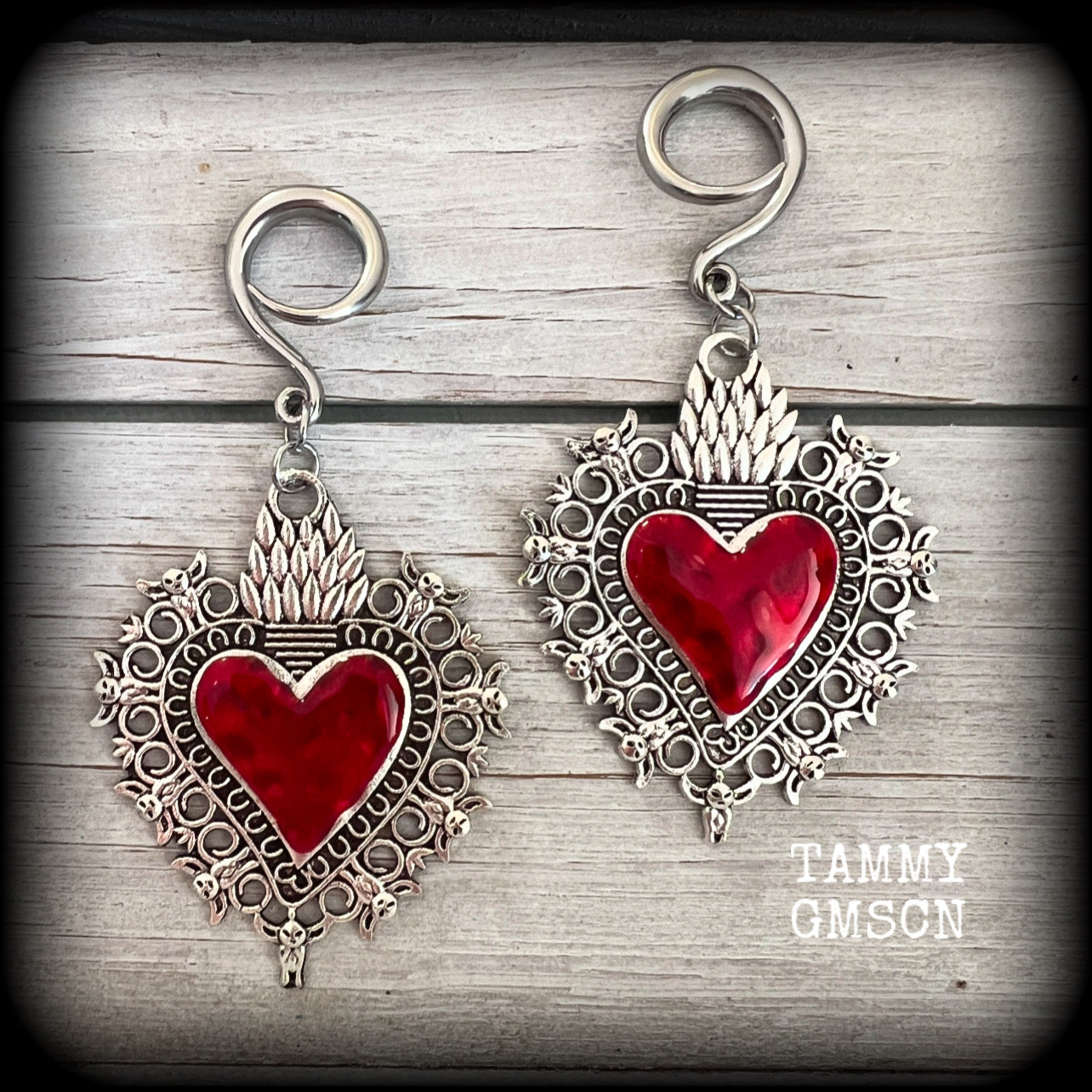 These gorgeous antique silver and red enamel gauged earrings feature big beautiful sacred hearts, measuring 8.5cms from tip to tip, and weighing approx 14 grams each.

This pair has been made on 6 gauge (4mm) surgical steel full curls, to be worn in stretched lobes.