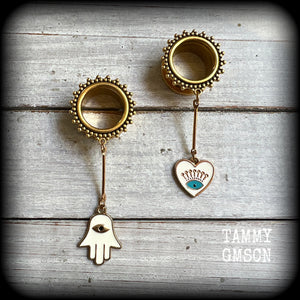 These tunnel earrings feature gold enamel hamsa hand and evil eye charms, weighing approx 9 grams each and measuring just over 6cms.
This pair have been made with 5/8" (16mm) gauge ornate titanium coated surgical steel screw fit tunnels.
