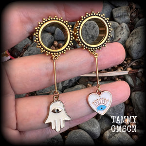 These tunnel earrings feature gold enamel hamsa hand and evil eye charms, weighing approx 9 grams each and measuring just over 6cms.
This pair have been made with 5/8" (16mm) gauge ornate titanium coated surgical steel screw fit tunnels.
