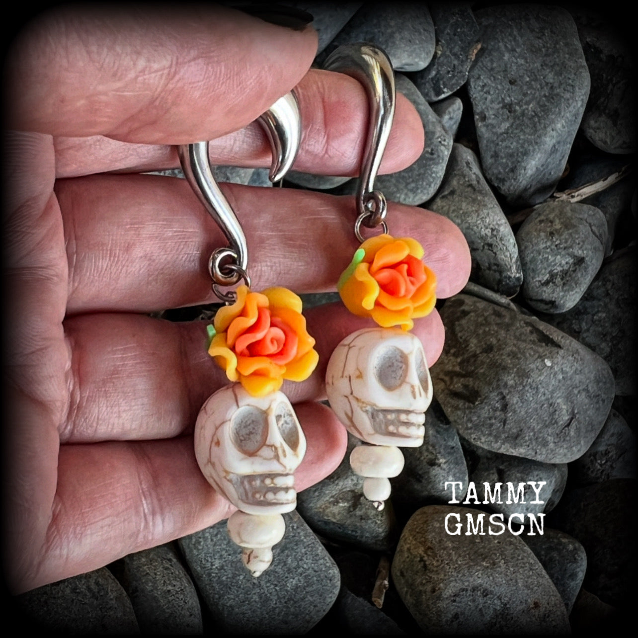 Featuring gorgeous orange and canary yellow roses sitting atop bone white stone skulls, these earrings have been made especially for Day of the Dead celebrations!

These unique earrings are nice and light weight at 15 grams a piece, and nice and dangly at just on 7.5cms from tip to tip.

This pair of beautiful gauged earrings has been made with 0 gauge (8mm) surgical steel half curl hooks, suitable for stretched lobes.